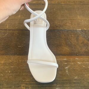 Never worn, but small mark on right shoe (see photo)